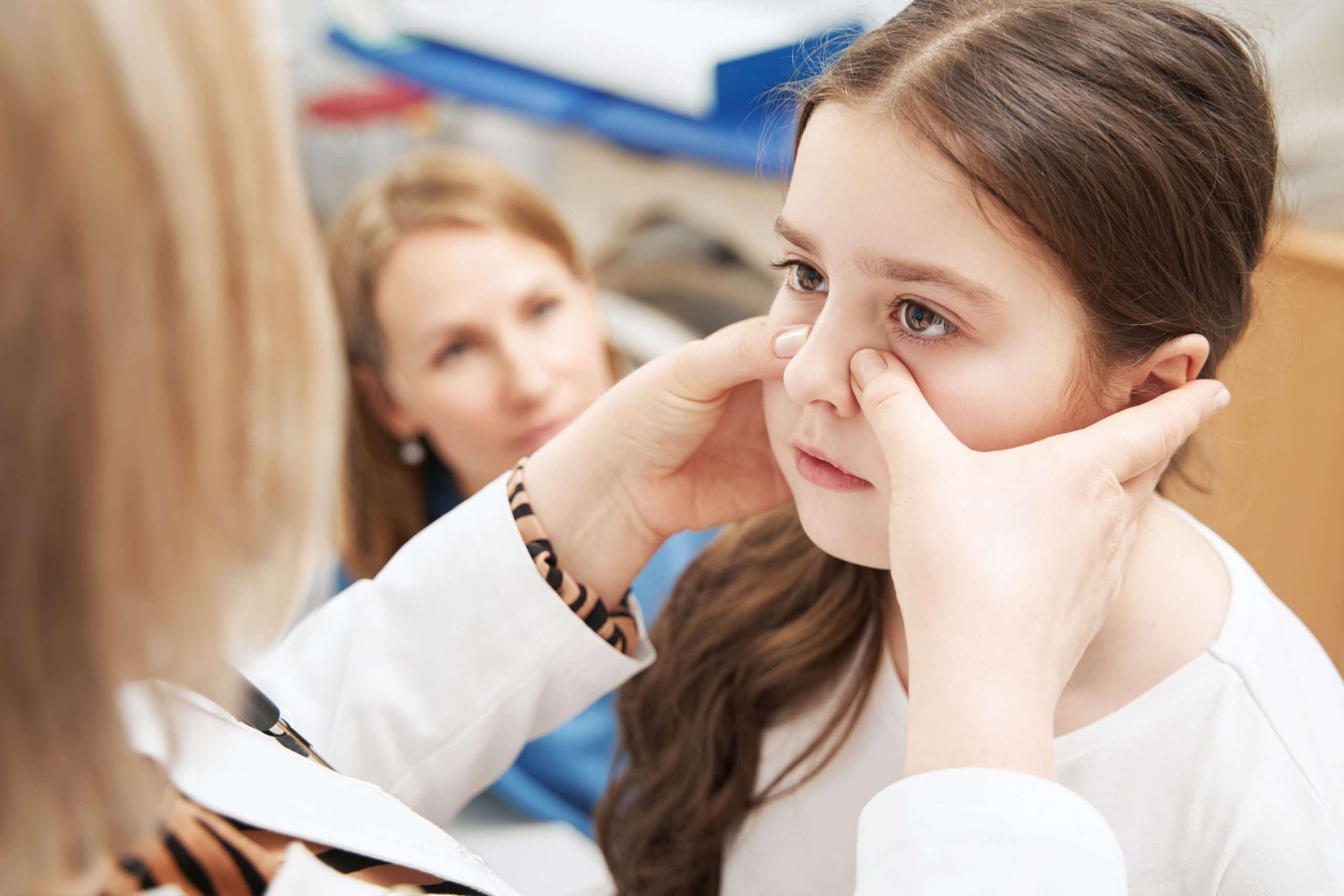 Female doctor examining little girl in clinic